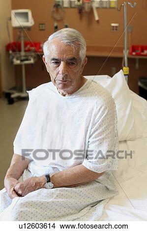 Elderly man sitting on hospital bed View Large Photo Image Picture - Elderly man sitting on hospital bed. Fotosearch