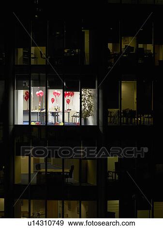 Stock Photo - Empty office after party, view from building exterior. Fotosearch
