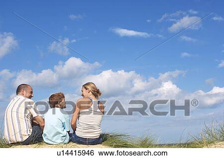 Family Sitting on Dunes View Large Photo Image Stock Photograph - Family Sitting on Dunes. Fotosearch