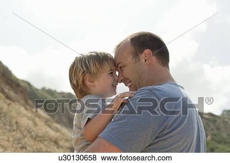 Stock Photo - Father and son rub noses, CA. Fotosearch