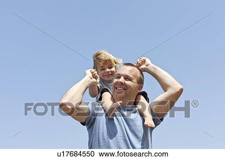 Stock Image - Father carries son on his shoulders, CA. Fotosearch