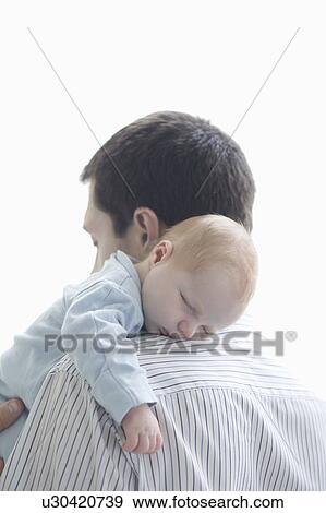 Stock Photo - Father holds newborn on shoulder. Fotosearch