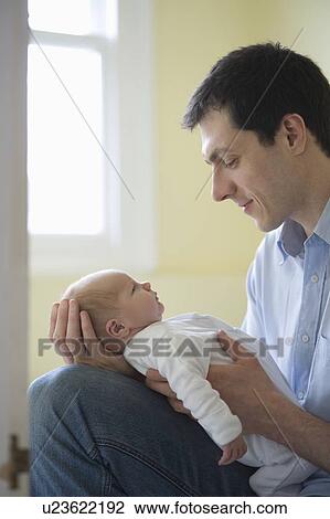Father holds newborn View Large Photo Image Stock Image - Father holds newborn. Fotosearch