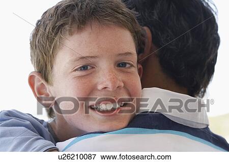 Father son hugging, portrait of son, head and shoulders View Large Photo Image Stock Photo - Father son hugging, portrait of son, head and shoulders. Fotosearch