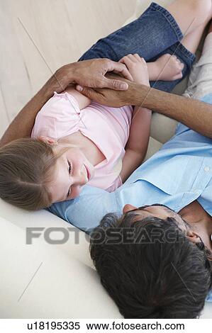 Father with daughter on couch, elevated view View Large Photo Image Stock Photography - Father with daughter on couch, elevated view. Fotosearch