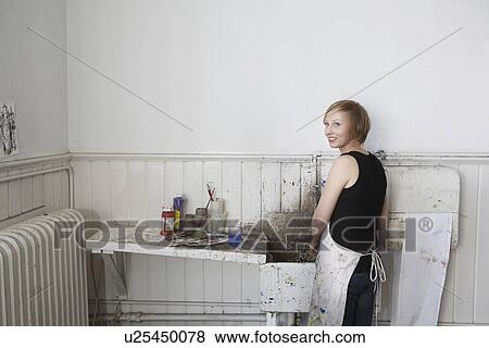 Female college student cleaning paint brushes at sink in art class View Large Photo Image Stock Photo - Female college student cleaning paint brushes at sink in art class. Fotosearch