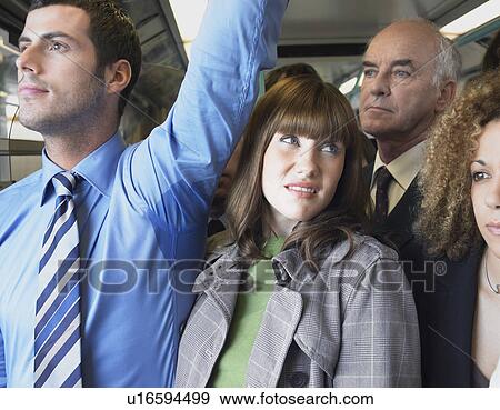 Stock Photo - Female Commuter Standing by Man's Wet Armpit on Train. Fotosearch