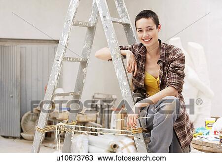 Female interior decorator sitting on ladder in work site, portrait View Large Photo Image Stock Image - Female interior decorator sitting on ladder in work site, portrait. Fotosearch