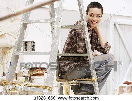 Female interior decorator sitting on ladder in work site, portrait View Large Photo Image Stock Image - Female interior decorator sitting on ladder in work site, portrait. Fotosearch