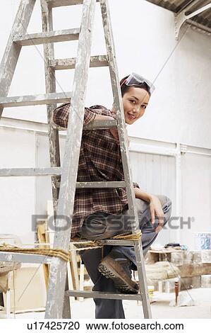 Female interior decorator sitting on ladder in work site, portrait View Large Photo Image Stock Image - Female interior decorator sitting on ladder in work site, portrait. Fotosearch