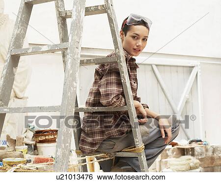 Female interior decorator sitting on ladder in work site, portrait View Large Photo Image Stock Photograph - Female interior decorator sitting on ladder in work site, portrait. Fotosearch