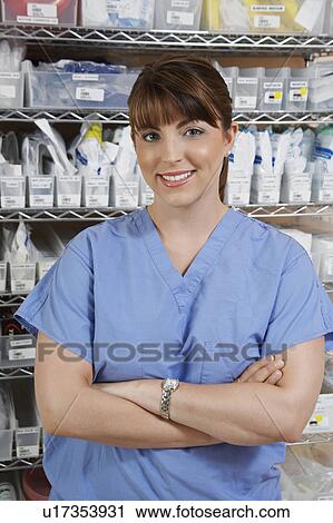 Stock Image - Female nurse in hospital room, portrait. Fotosearch