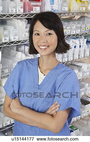 Stock Photo - Female nurse in hospital room, portrait. Fotosearch