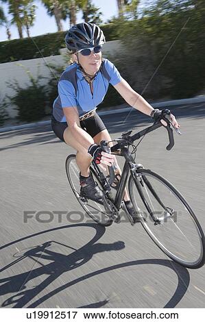 Female road cyclist View Large Photo Image Stock Photo - Female road cyclist. Fotosearch