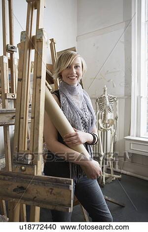Female student standing among easels in art college View Large Photo Image Stock Image - Female student standing among easels in art college. Fotosearch