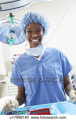 Stock Image - Female surgeon in operating room, portrait. Fotosearch