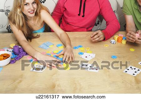 Friends Playing Cards, woman grabbing chips View Large Photo Image Stock Photo - Friends Playing Cards, woman grabbing chips. Fotosearch