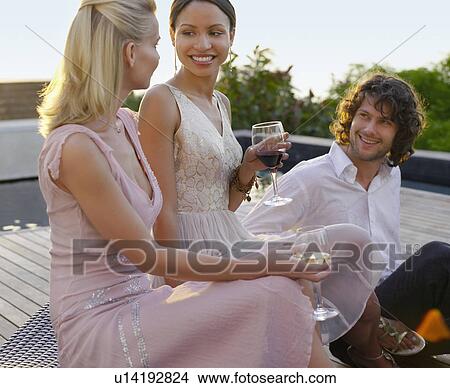 Friends sitting on porch Drinking and socialising View Large Photo Image Picture - Friends sitting on porch Drinking and socialising. Fotosearch