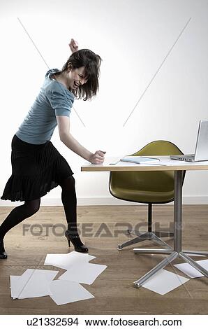 Picture - Furious woman hitting desk. Fotosearch