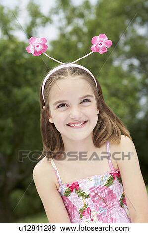 Girl in backyard Wearing Floral Deely Boppers, portrait View Large Photo Image Stock Photo - Girl in backyard Wearing Floral Deely Boppers, portrait. Fotosearch