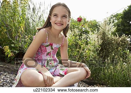 Picture - Girl Sitting in Meadow, close up. Fotosearch