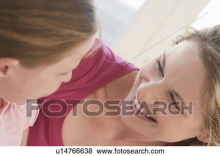 Girl with mother, smiling, close up View Large Photo Image Stock Photo - Girl with mother, smiling, close up. Fotosearch