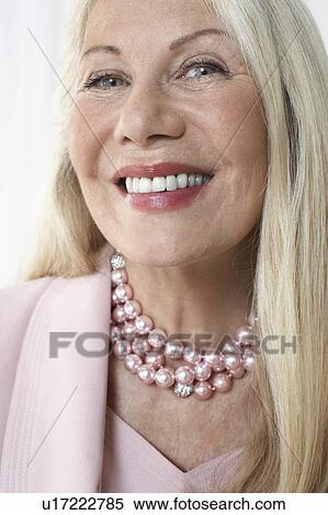 Stock Photography - Glamorous senior woman in studio, head and shoulders, close up. Fotosearch
