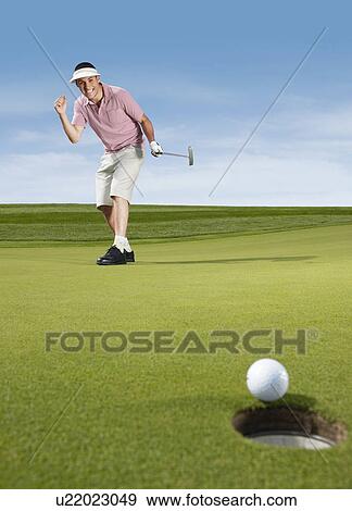 Golfer cheering after putting View Large Photo Image Stock Photo - Golfer cheering after putting. Fotosearch
