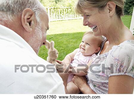 Grandparents playing with granddaughter in garden View Large Photo Image Stock Image - Grandparents playing with granddaughter in garden. Fotosearch