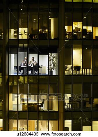 Group of business people at meeting in office, view from building exterior View Large Photo Image Stock Image - Group of business people at meeting in office, view from building exterior. Fotosearch