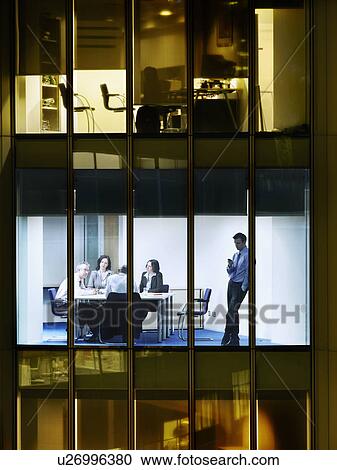 Group of business people at meeting in office, view from building exterior View Large Photo Image Stock Image - Group of business people at meeting in office, view from building exterior. Fotosearch