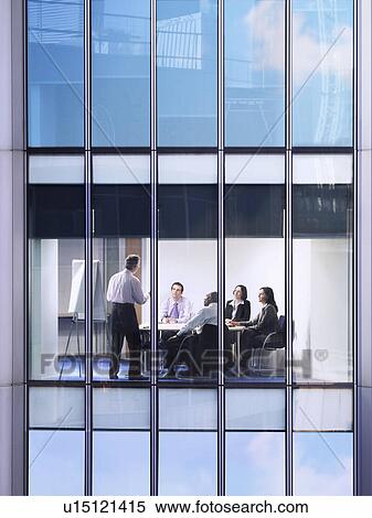 Group of business people at meeting in office, view from building exterior View Large Photo Image Stock Photography - Group of business people at meeting in office, view from building exterior. Fotosearch