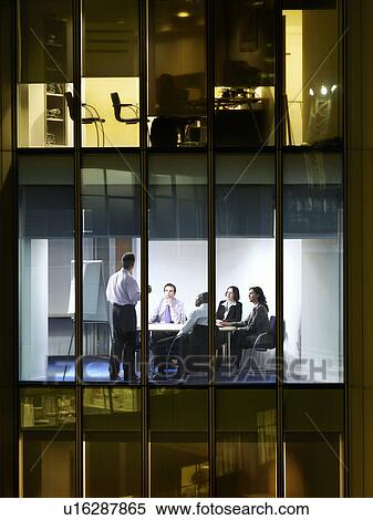 Group of business people at meeting in office, view from building exterior View Large Photo Image Stock Photography - Group of business people at meeting in office, view from building exterior. Fotosearch