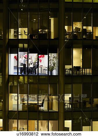 Group of business people having office party, view from building exterior View Large Photo Image Stock Image - Group of business people having office party, view from building exterior. Fotosearch