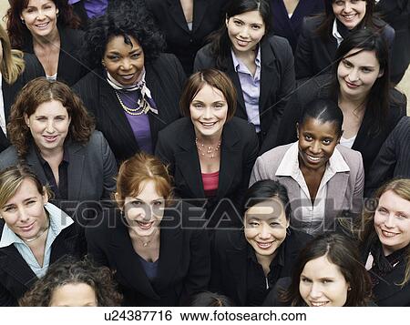 Stock Photograph - Group of business women looking up, portrait, elevated view, close up. Fotosearch