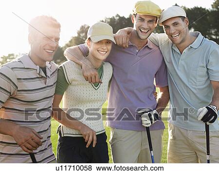 Stock Photo - Group of young golfers posing on court, portrait. Fotosearch