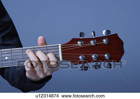 Hand Playing on Neck of Guitar, detail, close-up View Large Photo Image Picture - Hand Playing on Neck of Guitar, detail, close-up. Fotosearch