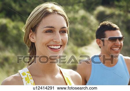 Happy Couple walking on beach trail, close up of woman View Large Photo Image Stock Image - Happy Couple walking on beach trail, close up of woman. Fotosearch