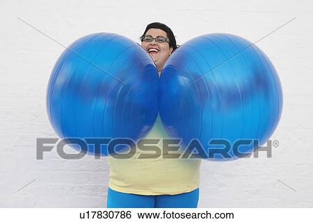 Happy Overweight Woman Holding Exercise Balls View Large Photo Image Stock Photograph - Happy Overweight Woman Holding Exercise Balls. Fotosearch