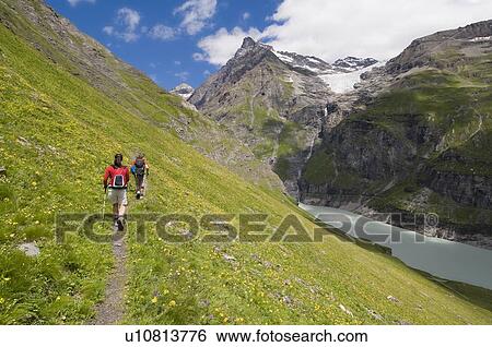 Stock Photograph - Hiking in the Val de Bagnes on the La Tsessette hiking trail, Canton du Valais. Fotosearch