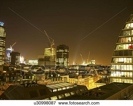 Illuminated cityscape with cranes at night View Large Photo Image Stock Photo - Illuminated cityscape with cranes at night. Fotosearch