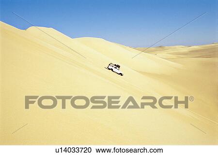 Jeep driving down sand dune View Large Photo Image Stock Image - Jeep driving down sand dune. Fotosearch