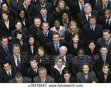 Stock Photo - Large group of business people looking up, portrait, elevated view. Fotosearch