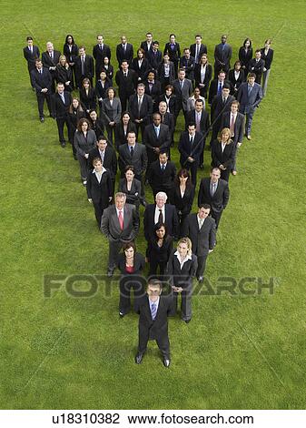 Large group of business people standing in triangle formation, elevated view View Large Photo Image Stock Image - Large group of business people standing in triangle formation, elevated view. Fotosearch