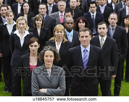 Stock Photo - Large group of business people standing on lawn, portrait, elevated view. Fotosearch