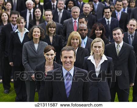 Stock Photo - Large group of business people standing on lawn, portrait, elevated view. Fotosearch