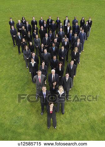 Large group of business people standing in triangle formation, elevated view View Large Photo Image Stock Photography - Large group of business people standing in triangle formation, elevated view. Fotosearch