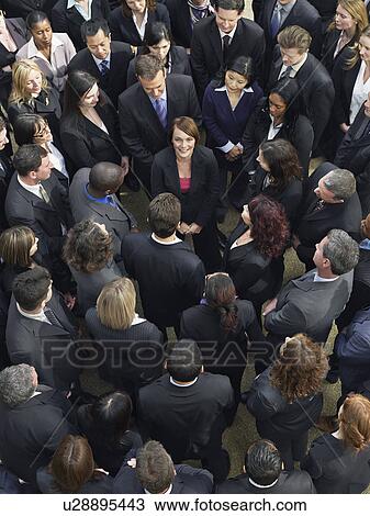Large group of business people surrounding woman looking up, elevated view View Large Photo Image Stock Image - Large group of business people surrounding woman looking up, elevated view. Fotosearch