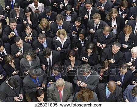 Large group of business people text messaging, elevated view View Large Photo Image Stock Photography - Large group of business people text messaging, elevated view. Fotosearch