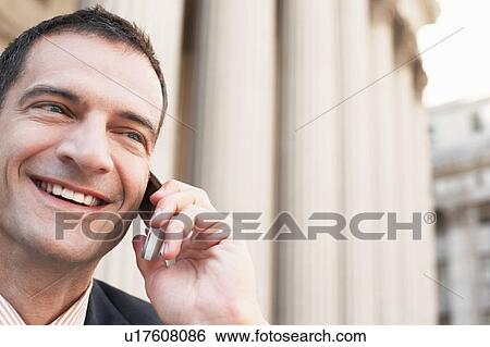 Lawyer using mobile phone outside courthouse View Large Photo Image Stock Photograph - Lawyer using mobile phone outside courthouse. Fotosearch